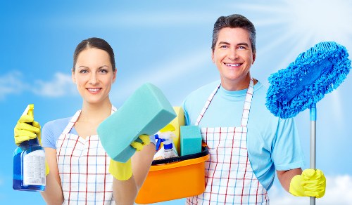 Steam cleaning equipment used for upholstery cleaning on a sectional sofa
